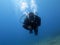 Closeup shot of a scuba diver under the blue water