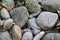 Closeup shot of several stones in different shapes with autumn dry leaves