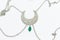 Closeup shot of a silver beautiful necklace with green precious stone