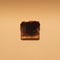 Closeup shot of a slice of burnt toast bread on a beige background