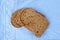 Closeup shot of slices of wheat bread laid on a blue fabric surface