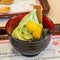 Closeup shot of a small bowl containing matcha-flavored ice cream.
