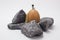 Closeup shot of a small figure of a miner working with rocks on a white background