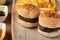 Closeup shot of small hamburgers, fries, and sauces