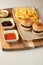 Closeup shot of small hamburgers, fries, and sauces