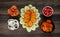 Closeup shot of small pieces of tomato, cucumber, onion, carrots, and red pepper in bowls