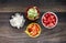 Closeup shot of small pieces of tomato, cucumber, onion, and red pepper inbowls