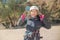 Closeup shot of a smiling female tenager wearing a helmet and zipline securing belts