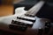 Closeup shot of a smooth body, pickups, bridge, knobs and strings of a bass guitar musical instrument with backlight