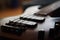 Closeup shot of a smooth body, pickups, bridge, knobs and strings of a bass guitar musical instrument with backlight