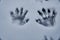 Closeup shot of snowy handprints