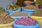 Closeup shot of spices and dried herbs in separate  blue and yellow stacks in Morocco
