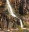 Closeup shot of a splashing cascading waterfall in the mountains