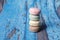 Closeup shot of a stack of delicious macarons on a wooden surface