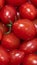 Closeup shot of a stack of juicy red cherry tomatoes.