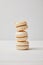 closeup shot of stack of macaroons on white wooden table