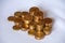 Closeup shot of stacks of gold coins on a white surface