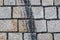 Closeup shot of stained brick street with wheel marks as a background