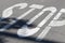 Closeup shot of a Stop written in white letters on a road