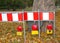 Closeup shot of street signs with red alert signs in a park