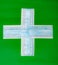 Closeup shot of surgical mask form with cross pattern isolated on a green background