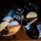 Closeup shot of sweet buns, chocolate and a glass of wine on a wooden table