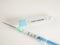 Closeup shot of a syringe with a COVID19 vaccine tube isolated on a white background