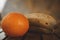 Closeup shot of a tasty looking tangerine and bananas  on a wooden table