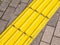 Closeup shot of textured yellow sidewalk sections for blind people