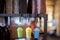 Closeup shot of three cool colorful trinkets with the shape of coffee cup hanged on an iron hanger