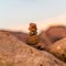 Closeup shot of tiny stones in a small cairn surrounded by rocks  - the concept of harmony