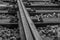 Closeup shot of tracks of a railway line in grayscale