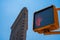 Closeup shot of a traffic light and the Flatiron building in New York, USA