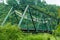 A closeup shot of Truss bridge taken from front. This bridge is painted green for protection against corrosion