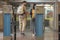 closeup shot of turnstiles and couple of travelers with backpacks