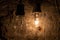 Closeup shot of two bare light bulbs on an old wall