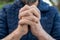 Closeup shot of two interlocked hands of a person praying