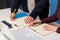 Closeup shot of two office workers signing a document