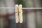 Closeup shot of two plastic clothespins on a rope on a blurred background