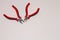 Closeup shot of two red precision cutter pliers isolated on a white background