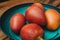 Closeup shot of typical Colombian fruits called tomate de arbol (tamarillo) on a blue plate