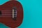 Closeup shot of a ukulele soundboard part on a turquoise background