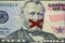 Closeup shot of the Ulysses s. grant face on the dollar bill with an x painted on his mouth