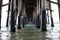 Closeup shot under pier with calm blue sea