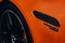 Closeup shot of the V8 BITURBO on a luxury Mercedes-Benz AMG SL with orange color