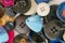 Closeup shot of a variety of colorful buttons arranged on a flat wooden table surface