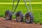 Closeup shot of wheels of western circular sprinkler on a greenfield