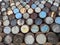 Closeup shot of Whisky barrels stacked on top of each other in an outdoor field