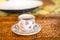 Closeup shot of a white ceramic floral mug with coffee