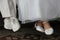 Closeup shot of white footwear of the groom and bride